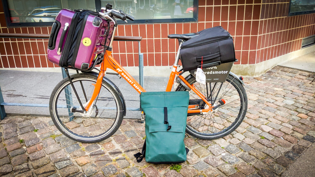 A bike with two suitcases on top